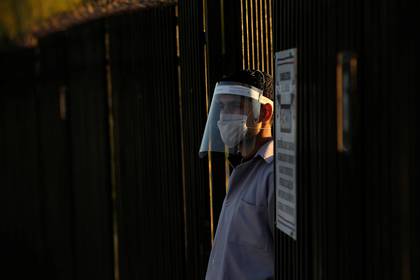 A worker from U.S. auto parts maker Aptiv Plc looks on as he arrives at the plant during the coronavirus disease (COVID-19) outbreak in Ciudad Juarez, Mexico May 18, 2020. REUTERS/Jose Luis Gonzalez