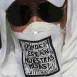 A demonstrator wearing a mask against the spread of the new coronavirus that has a message that reads in Spanish “Where are our dauthers?” participates in a protest by mothers of missing children in Mexico City, Sunday, May 10, 2020. (AP Photo/Fernando Llano)