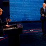 U.S. President Donald Trump answers a question as Democratic presidential candidate former Vice President Joe Biden listens during the second and final presidential debate at the Curb Event Center at Belmont University in Nashville, Tennessee, U.S., October 22, 2020. Morry Gash/Pool via REUTERS