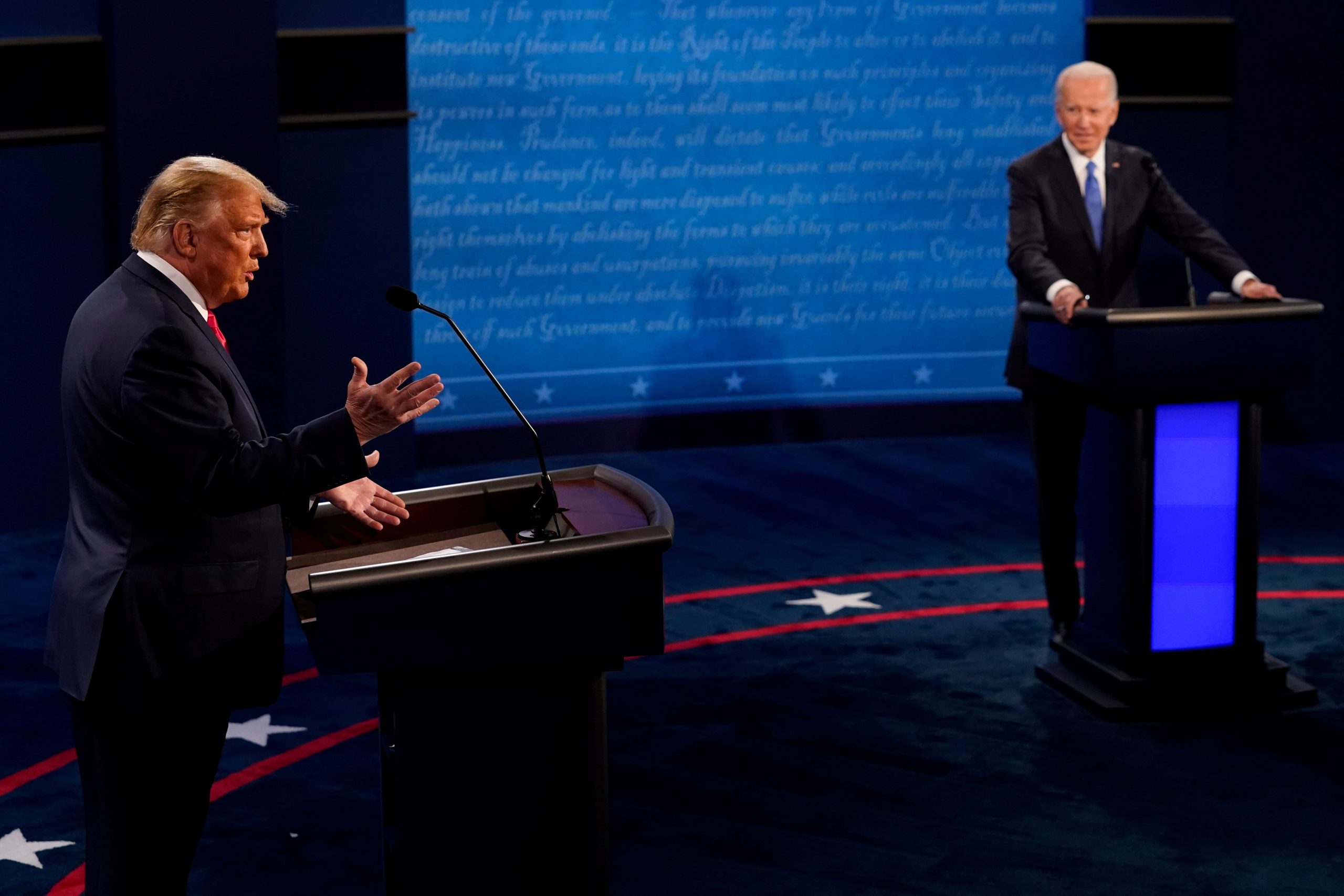 U.S. President Donald Trump answers a question as Democratic presidential candidate former Vice President Joe Biden listens during the second and final presidential debate at the Curb Event Center at Belmont University in Nashville, Tennessee, U.S., October 22, 2020. Morry Gash/Pool via REUTERS